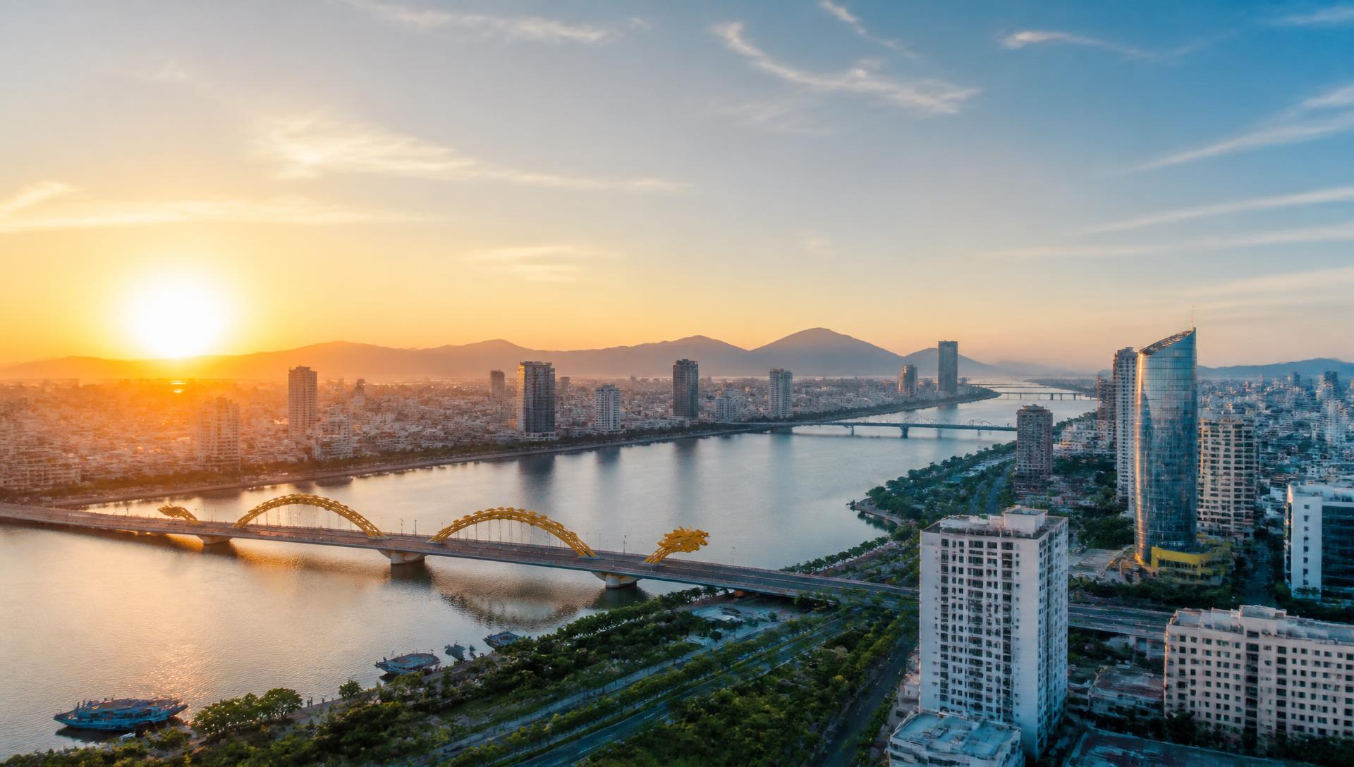 Da Nang skyline at sunrise with the Dragon Bridge over the Han River